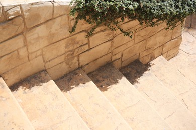 View of beautiful stone stairs near brick wall outdoors