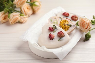 Tray with scented sachets on white wooden table