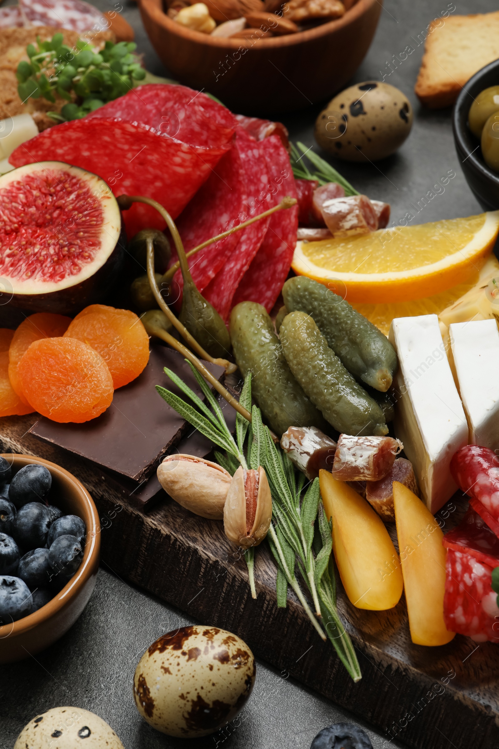 Photo of Set of different delicious appetizers served on grey table, closeup