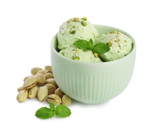 Photo of Bowl of delicious pistachio ice cream with mint on white background