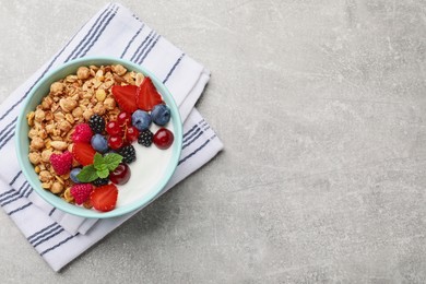 Photo of Flat lay composition with tasty granola and berries on light grey table. Space for text