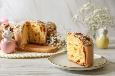 Delicious Italian Easter dove cake (traditional Colomba di Pasqua) and festive decor on white wooden table