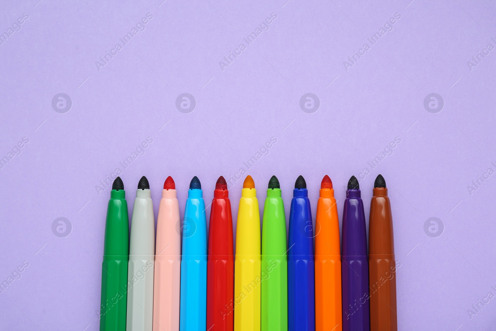 Photo of Different colorful markers on light background, flat lay. Space for text