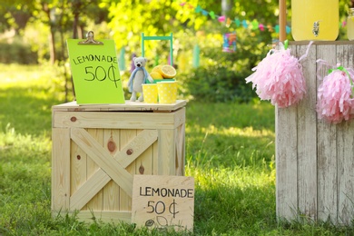 Photo of Decorated lemonade stand in park. Summer refreshing natural drink
