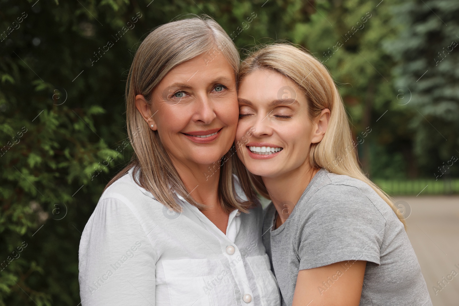 Photo of Happy mature mother and her daughter outdoors