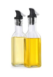 Photo of Glass bottles with cooking oil on white background