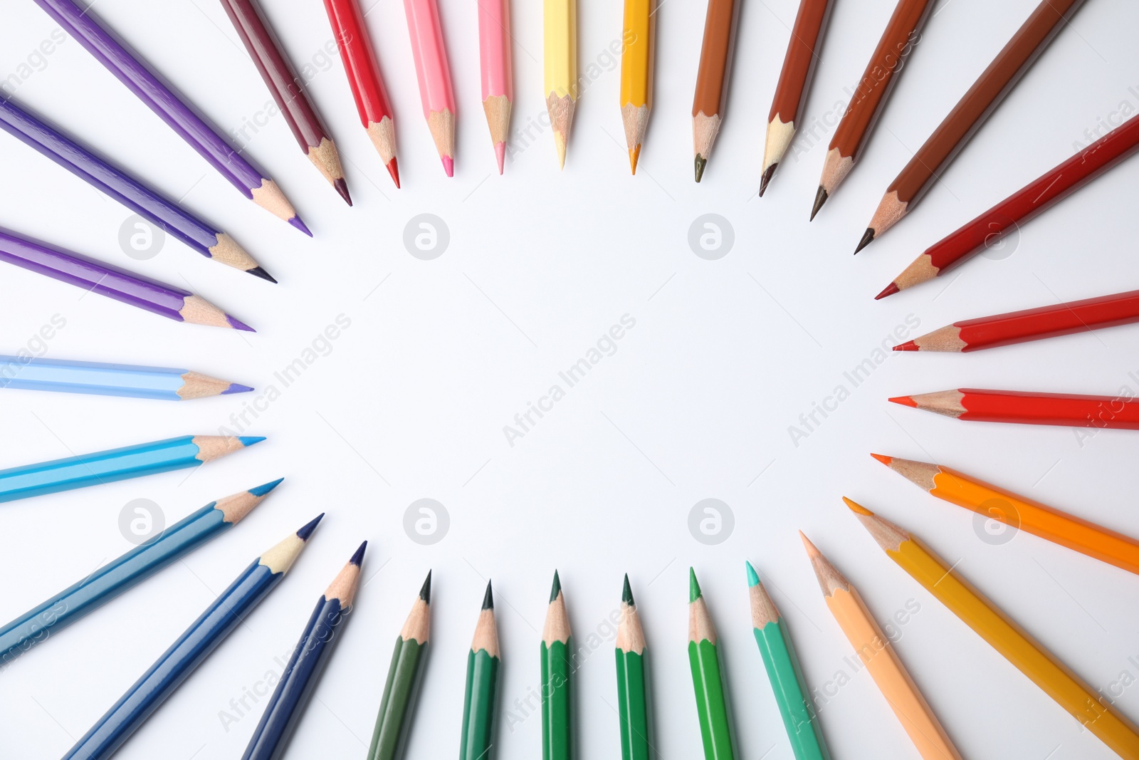 Photo of Frame made of color pencils on white background, top view
