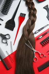 Flat lay composition with hair salon tools on color background