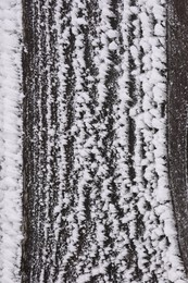 Wooden wall covered with hoarfrost on snowy day, closeup