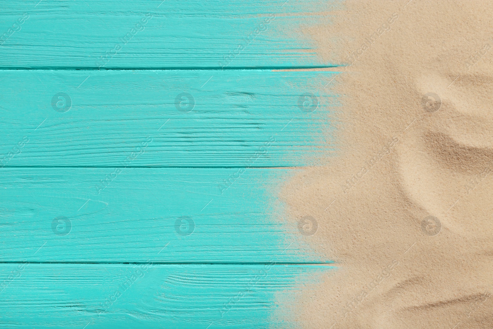 Photo of Beach sand on wooden background, top view with space for text