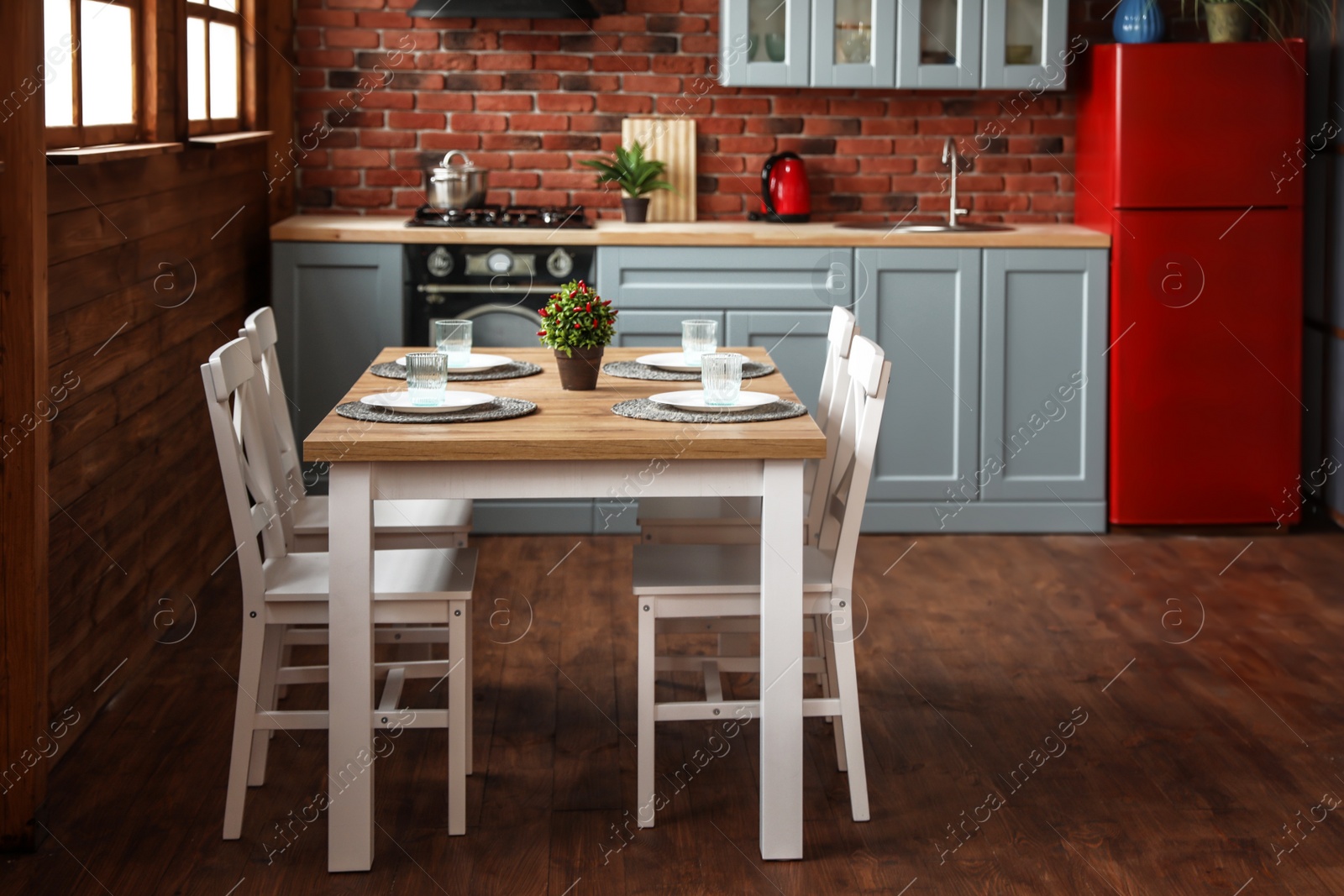 Photo of Stylish kitchen interior with dining table and chairs