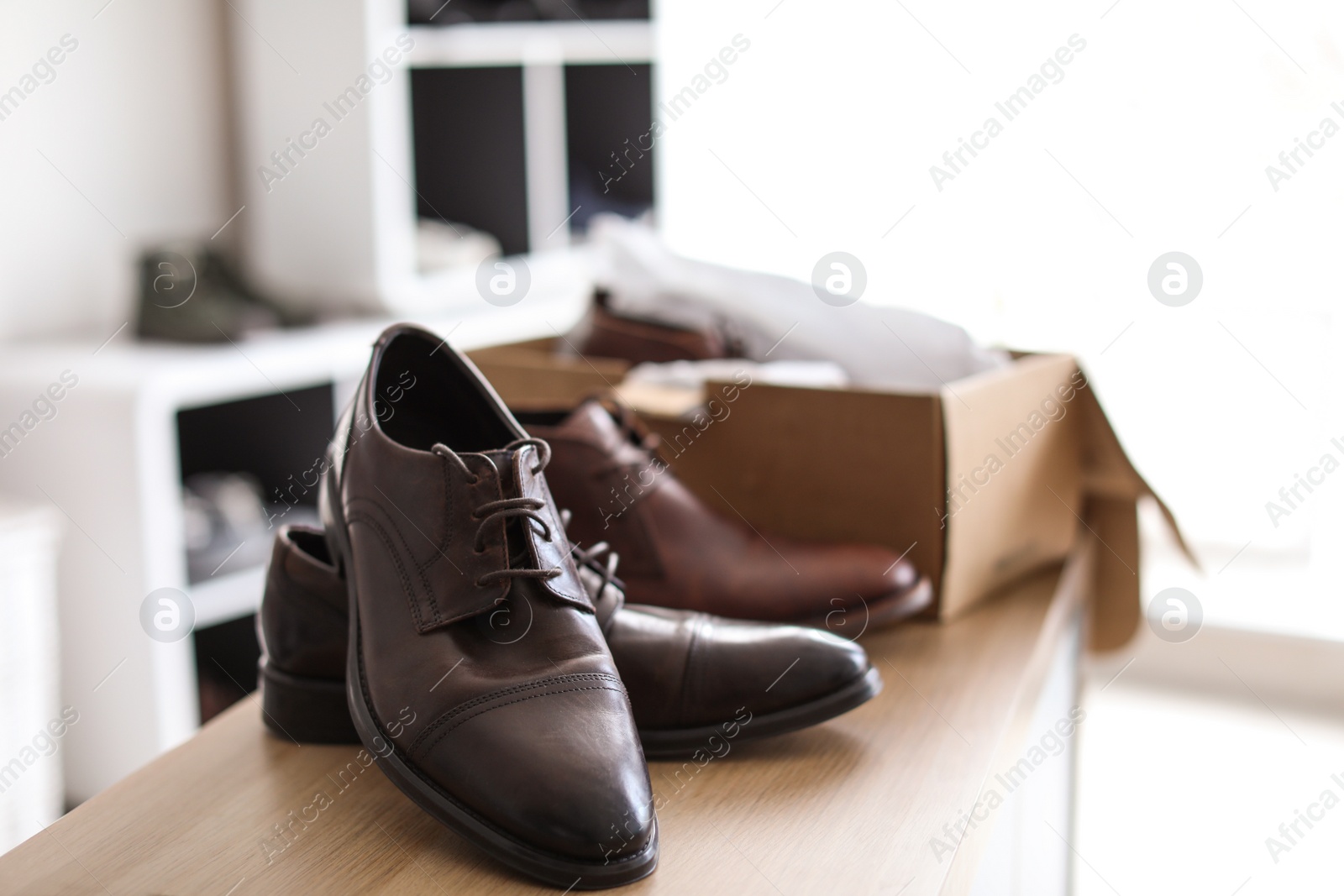 Photo of Stylish male shoes on counter in store