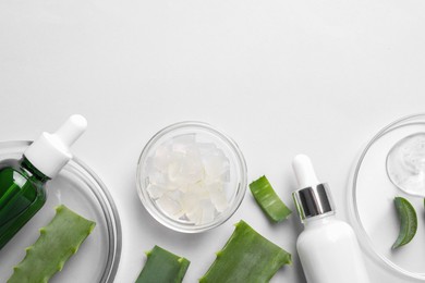 Photo of Flat lay composition with cosmetic products and cut aloe vera on white background. Space for text