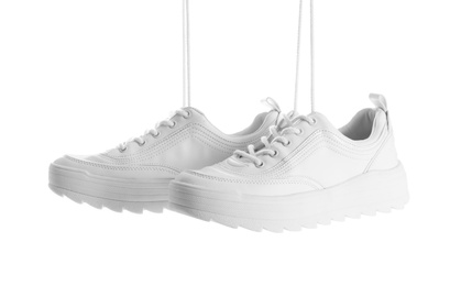 Photo of New stylish sneakers on white background. Trendy footwear