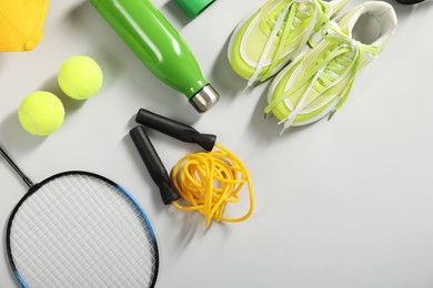 Photo of Different sports equipment on light grey background, flat lay. Space for text