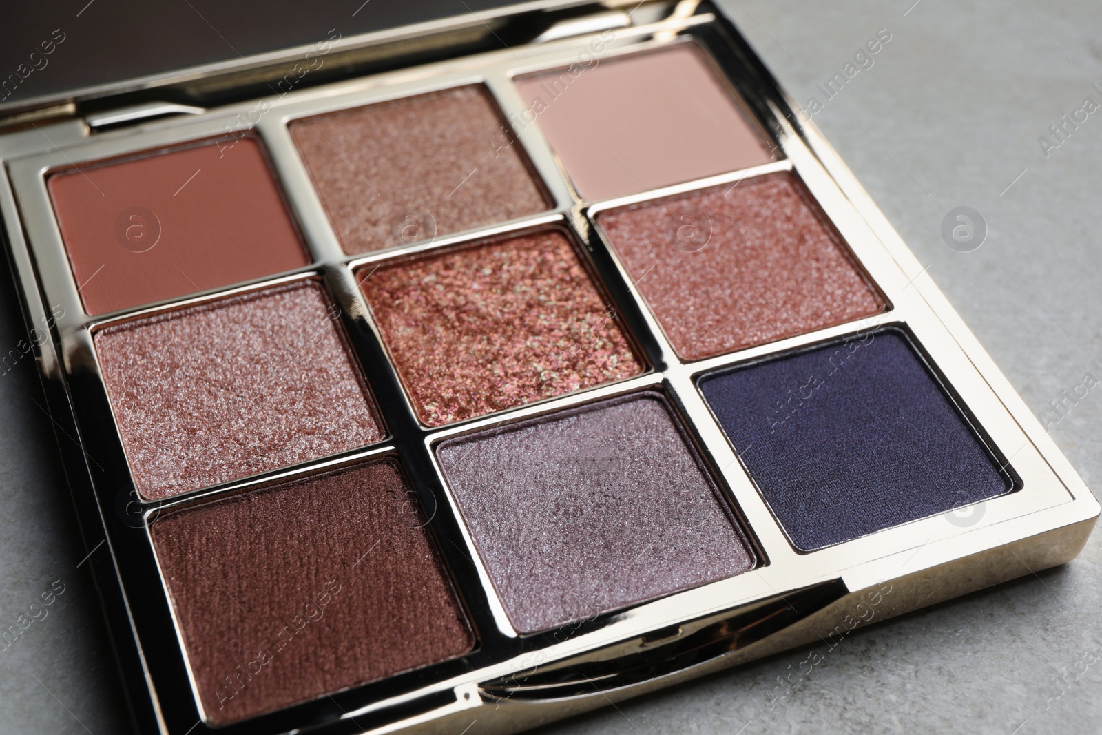 Photo of Beautiful eye shadow palette on grey table, closeup