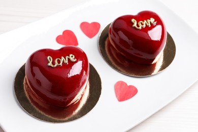 Photo of St. Valentine's Day. Delicious heart shaped cakes on table, closeup