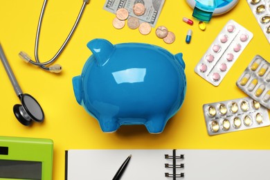 Photo of Flat lay composition with piggy bank on yellow background. Medical insurance