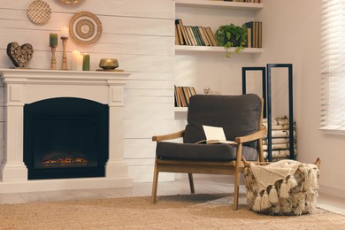 Photo of Cozy living room interior with comfortable armchair near fireplace