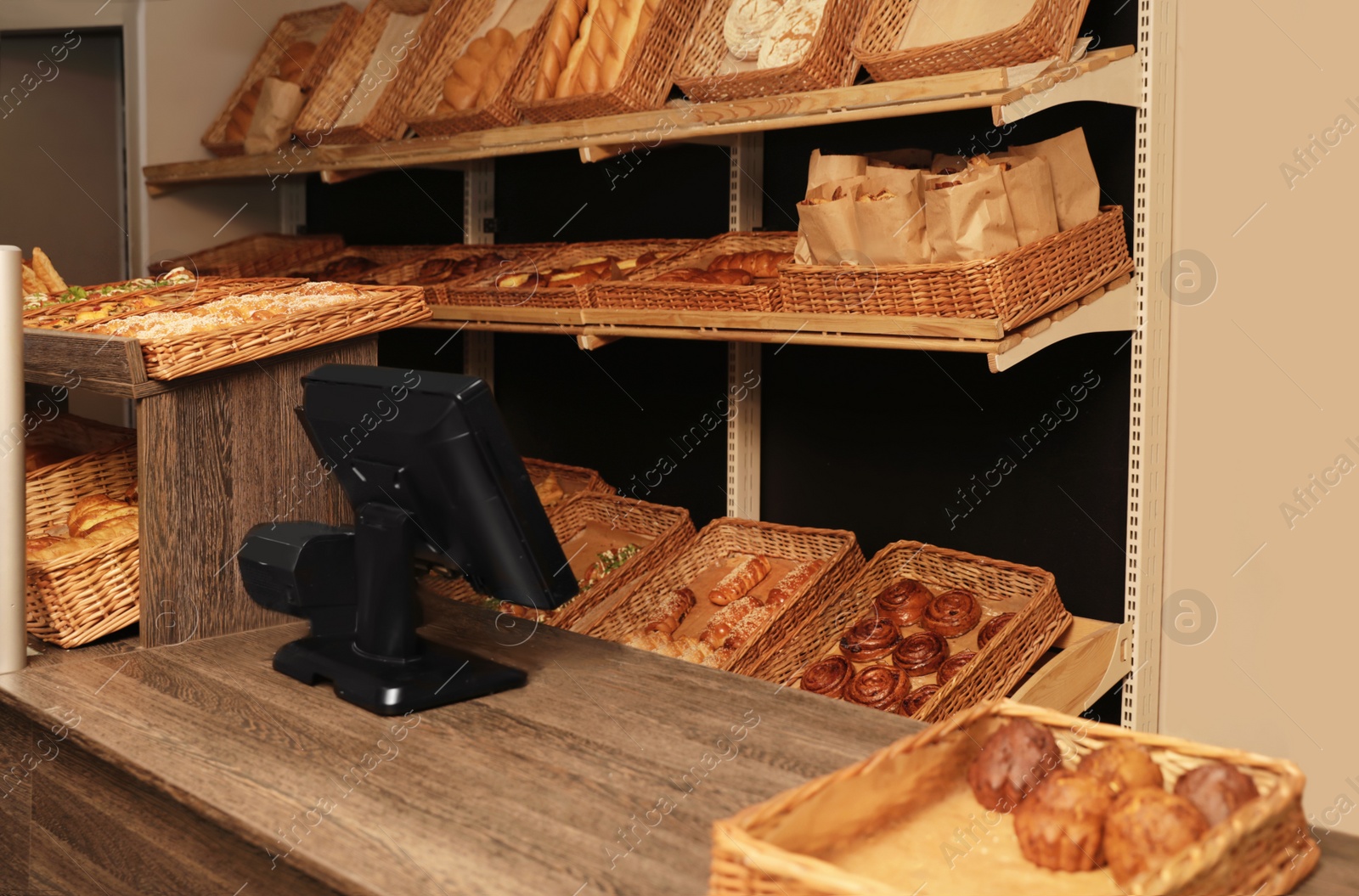 Photo of Fresh products and cashier desk in bakery
