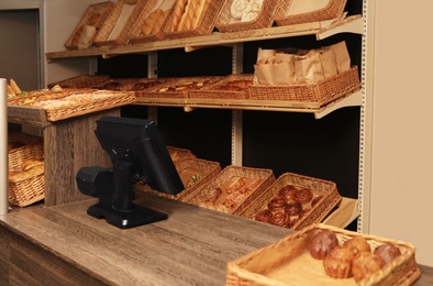 Photo of Fresh products and cashier desk in bakery