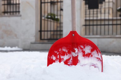 Photo of Snow shovel with wooden handle outdoors. Space for text
