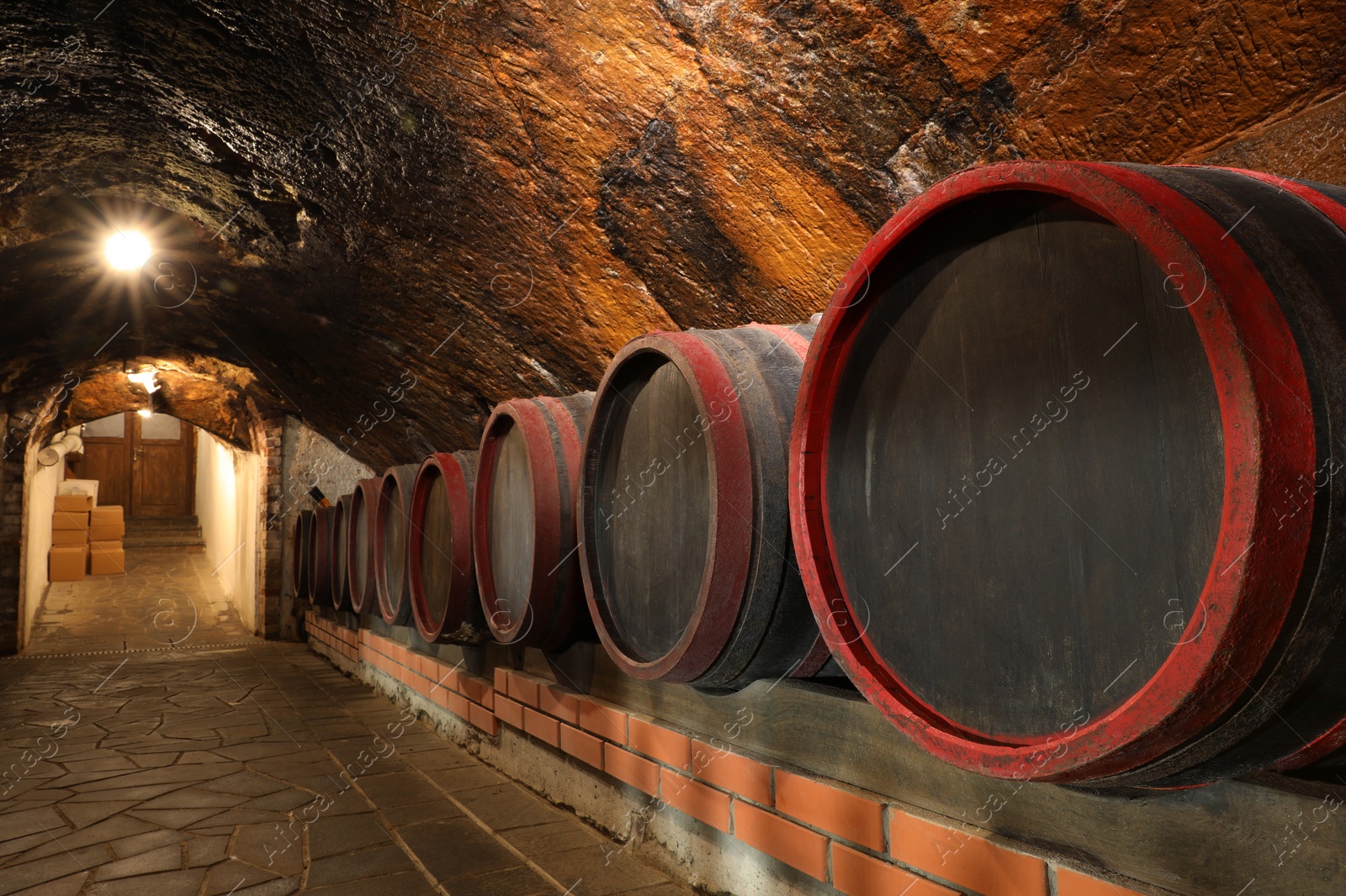 Photo of Beregove, Ukraine - June 23, 2023: Many wooden barrels with alcohol drinks in cellar