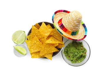 Mexican sombrero hat, tequila with lime, nachos chips and guacamole in bowls isolated on white, top view