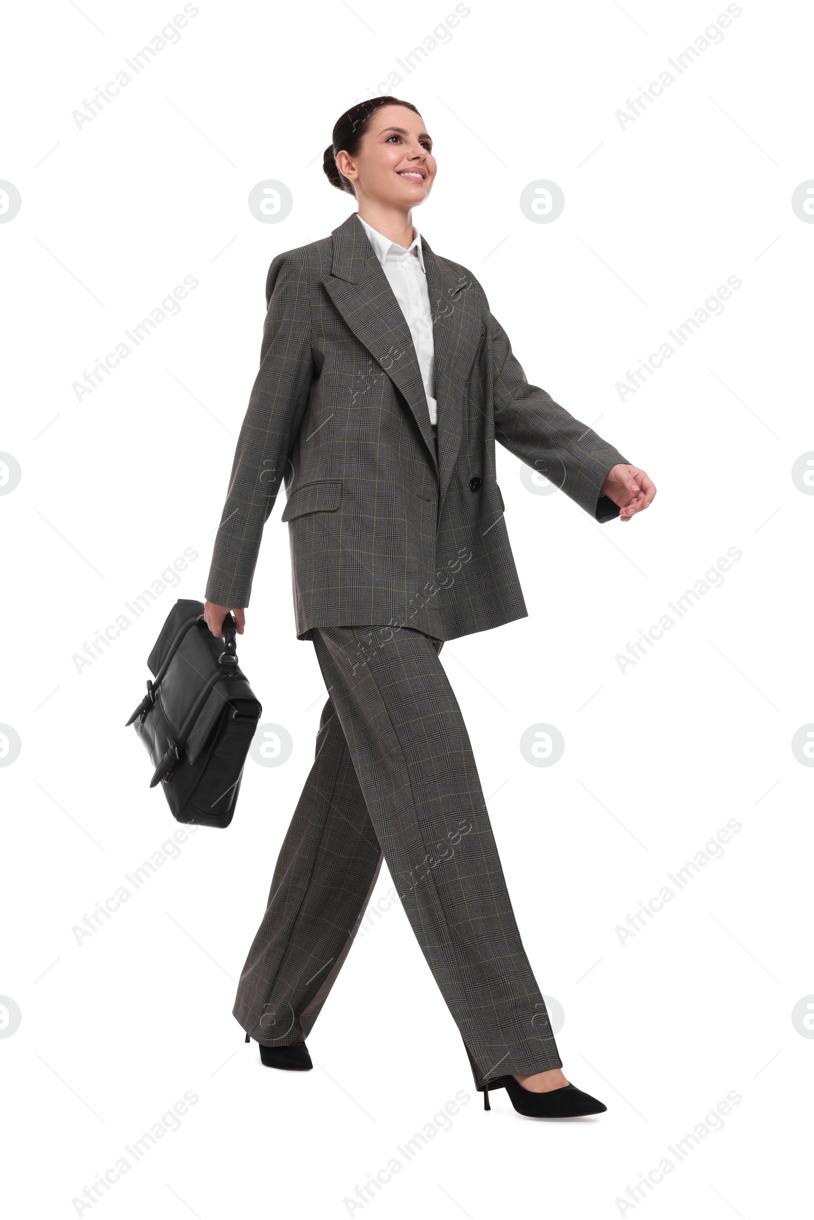 Photo of Beautiful businesswoman in suit with briefcase walking on white background