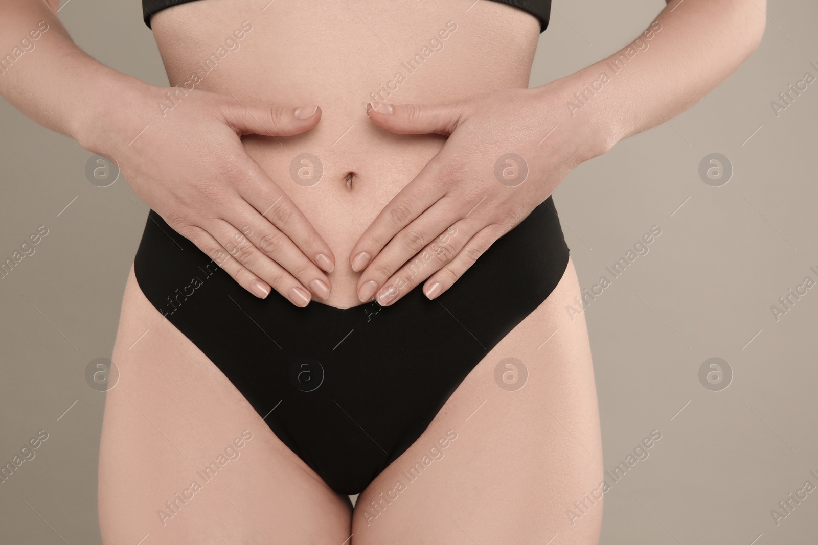 Photo of Gynecology. Woman in underwear on grey background, closeup