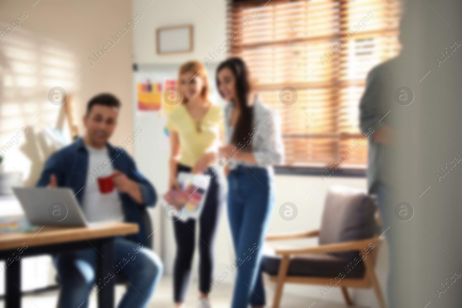 Image of Blurred view of professional interior designers working in office