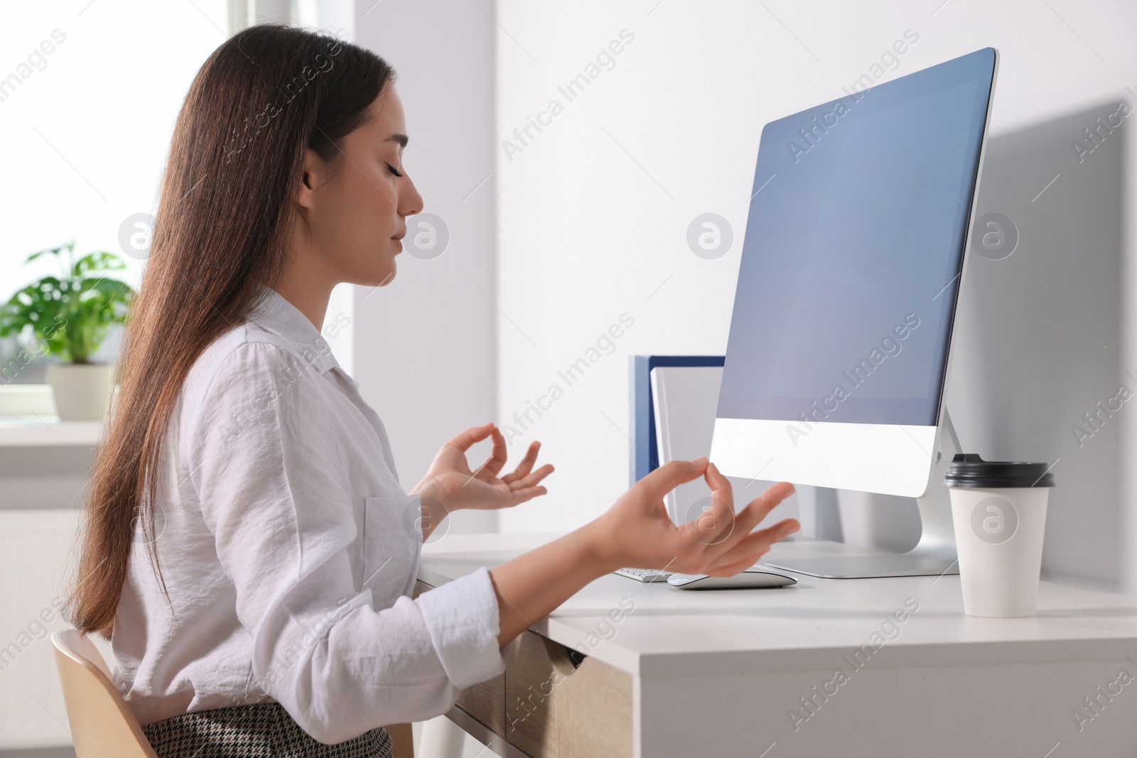 Photo of Find zen. Woman taking break from work at table in room