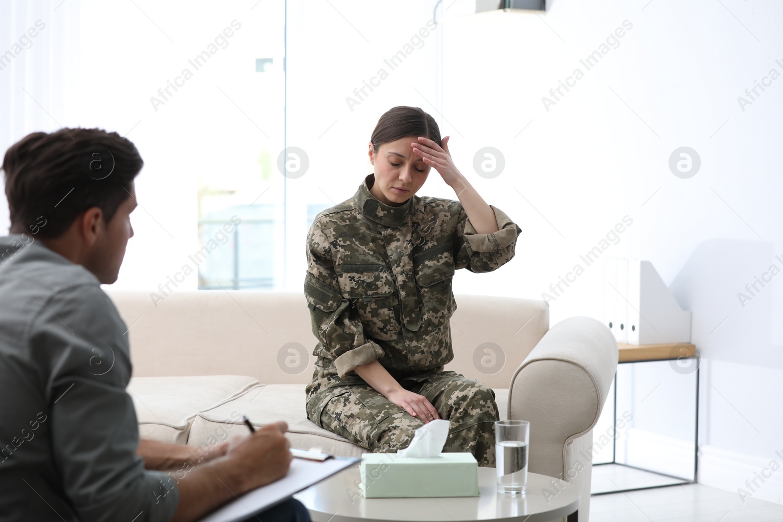 Photo of Psychotherapist working with female military officer in office