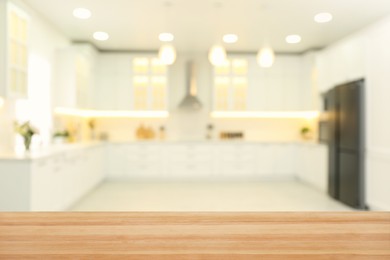 Image of Empty wooden table and blurred view of stylish kitchen interior. Mockup for design