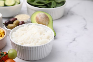 Ingredients for poke bowl on white marble table, closeup. Space for text