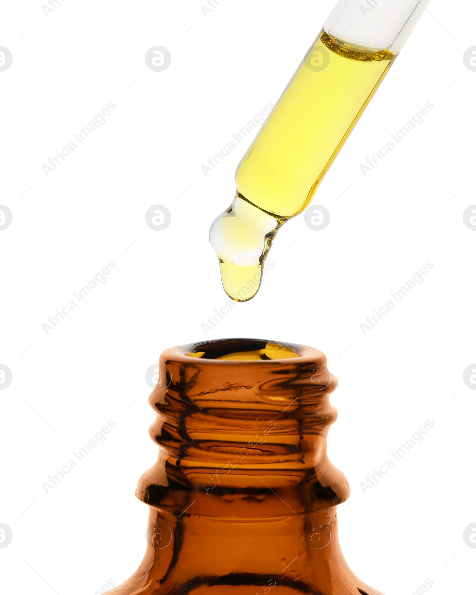 Photo of Dripping tincture from pipette into bottle isolated on white