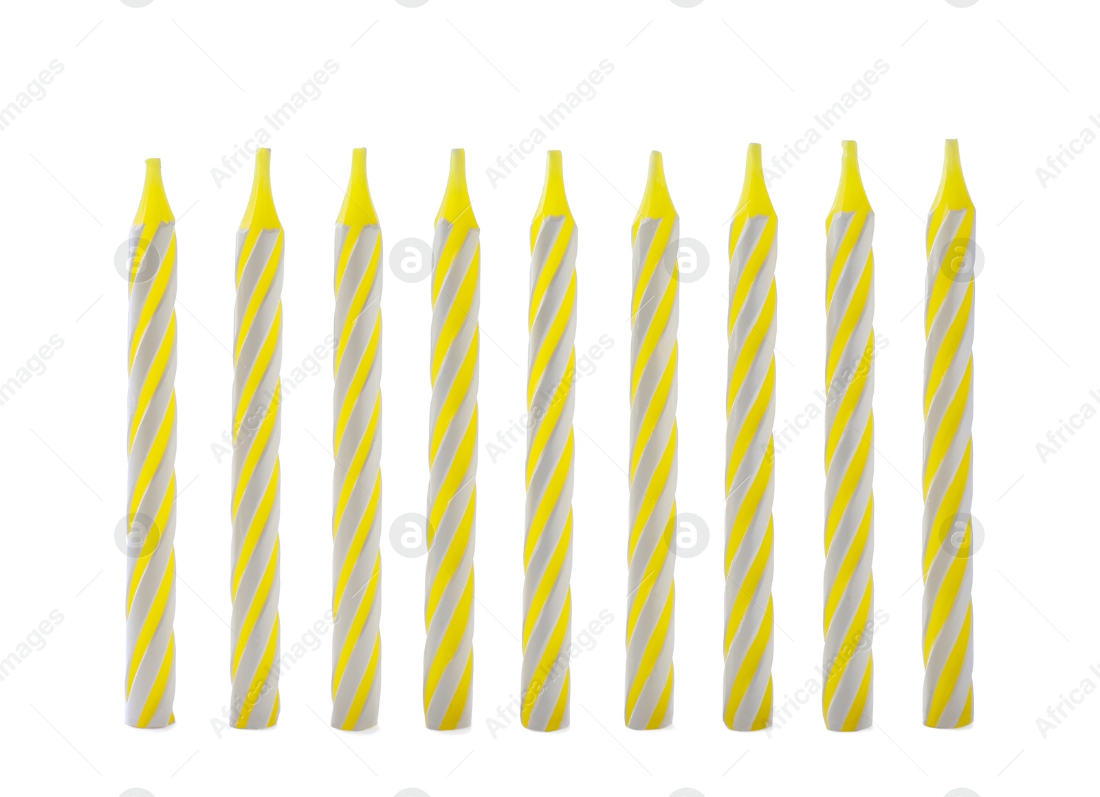 Photo of Yellow striped birthday candles isolated on white