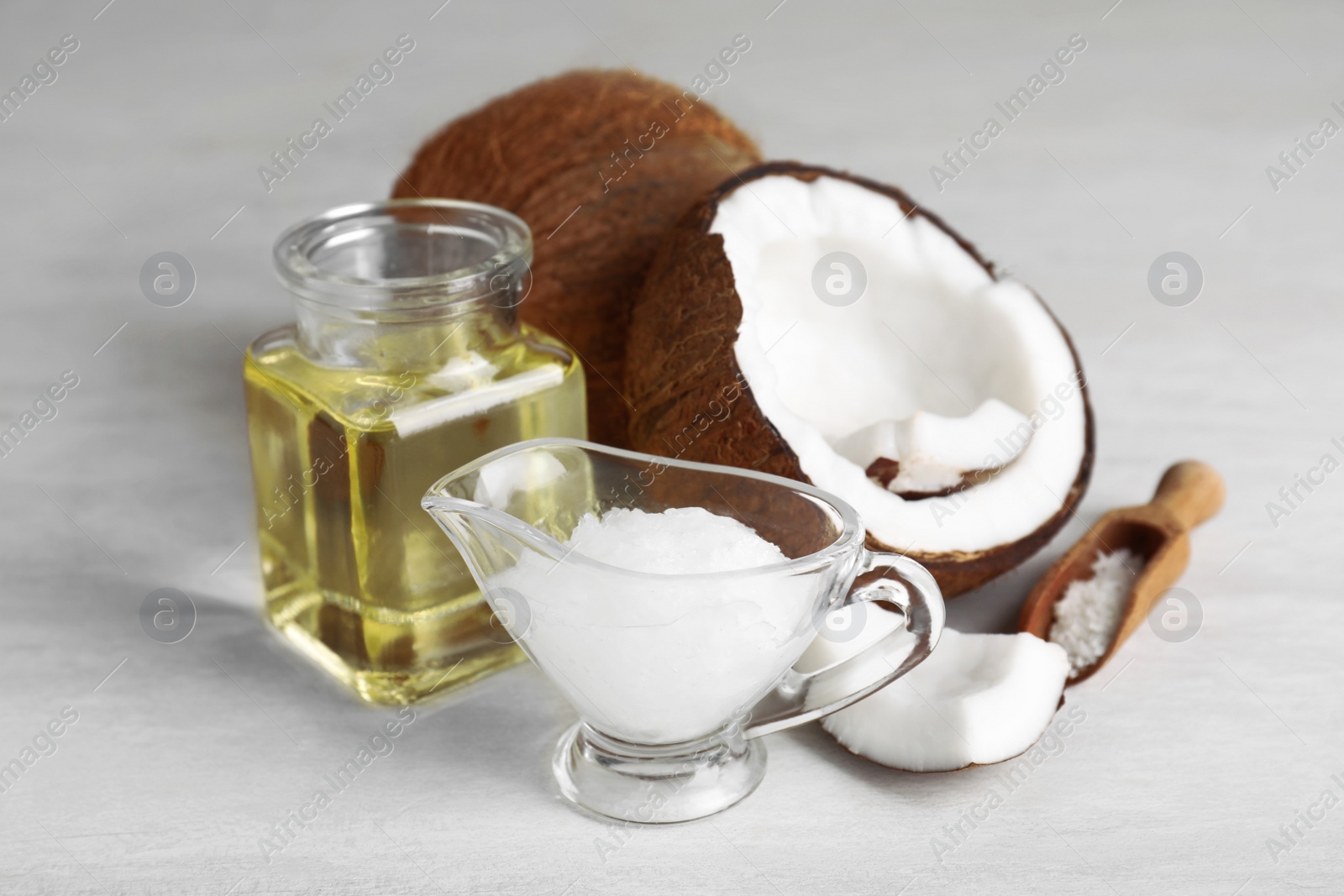 Photo of Composition with natural organic coconut oil on table