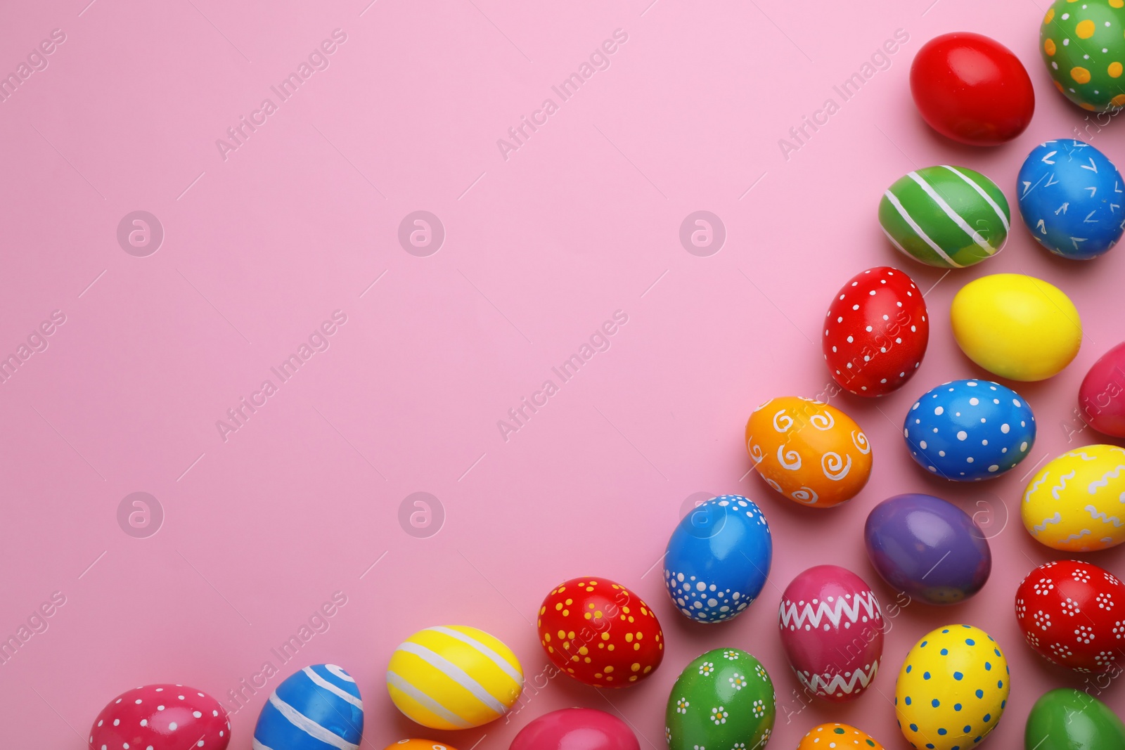 Photo of Decorated Easter eggs and space for text on color background, top view