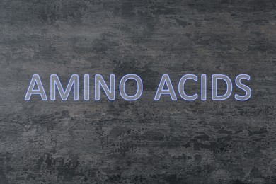 Illustration of Text Amino Acids on grey stone surface