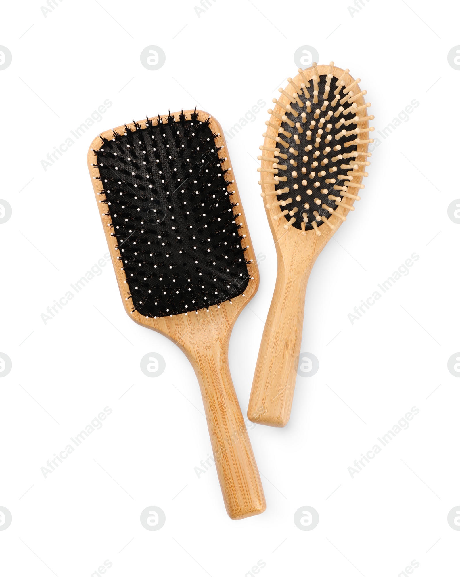 Photo of New wooden hair brushes isolated on white, top view