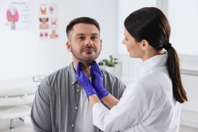 Photo of Endocrinologist examining thyroid gland of patient at hospital