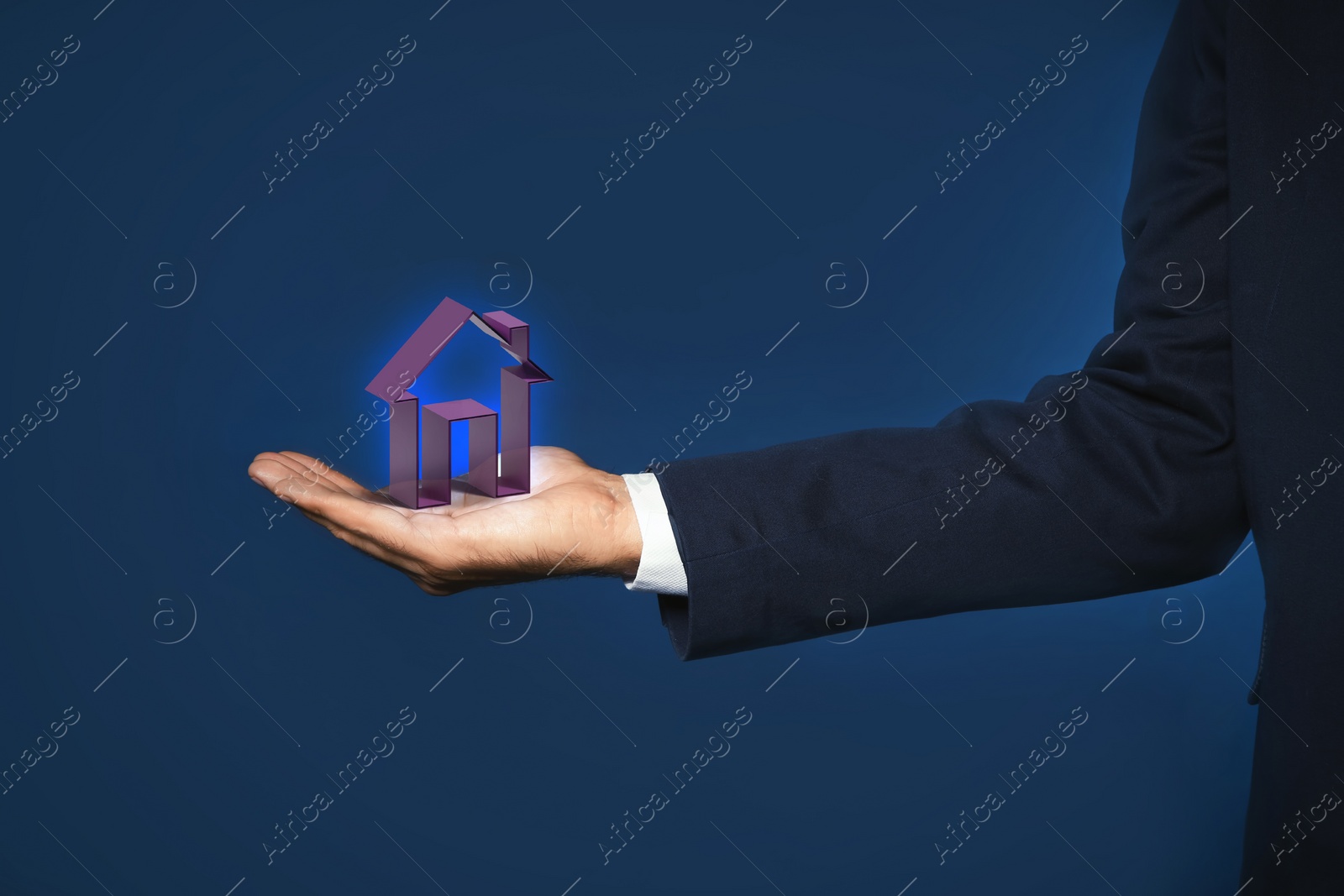 Image of Mortgage rate. Man holding virtual house on dark blue background, closeup
