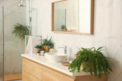 Stylish bathroom interior with countertop, mirror and shower stall. Design idea