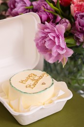 Photo of Delicious decorated Birthday cake and beautiful flowers on table indoors, closeup