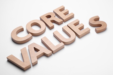 Photo of Phrase CORE VALUES made of wooden letters on white background