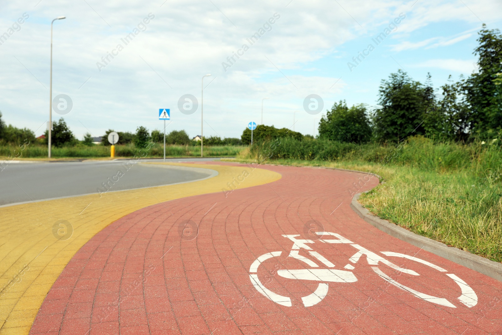 Photo of Red bicycle lane on pavement along road