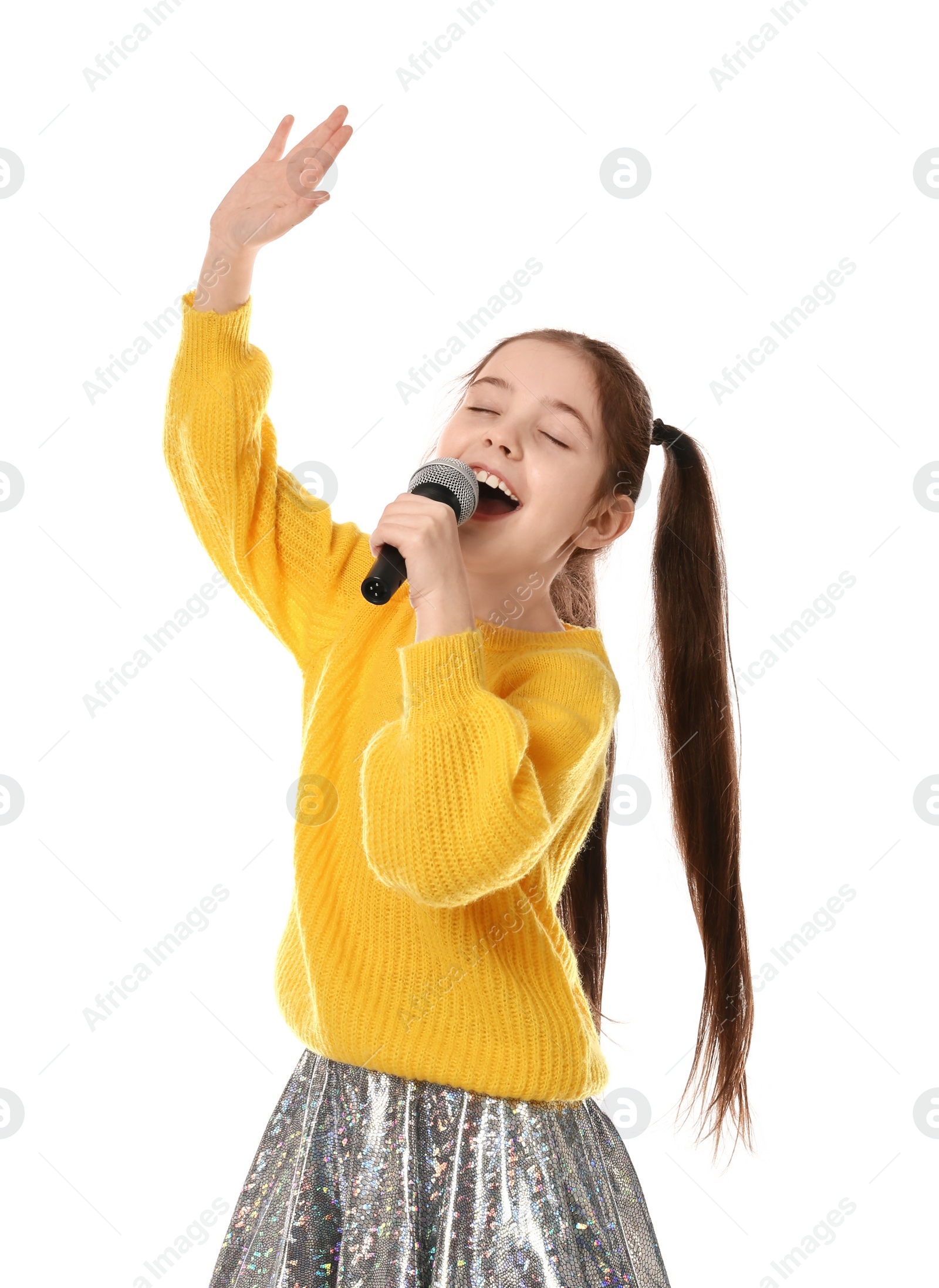 Photo of Little girl singing into microphone on white background