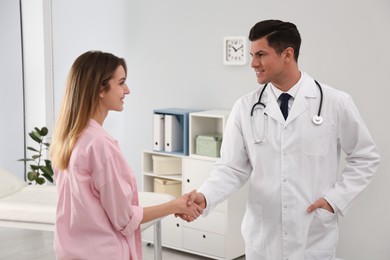 Doctor and patient shaking hands in clinic