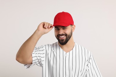 Photo of Man in stylish red baseball cap on white background